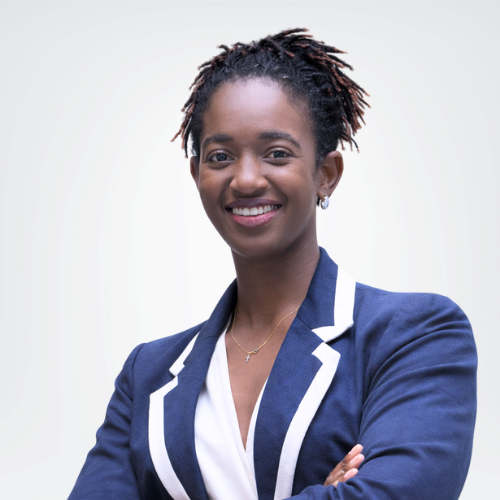 A woman CFO in a navy blazer with white trim stands smiling with arms crossed against a light background. - kotsoconsulting.com Thoko Kaseke, CPA