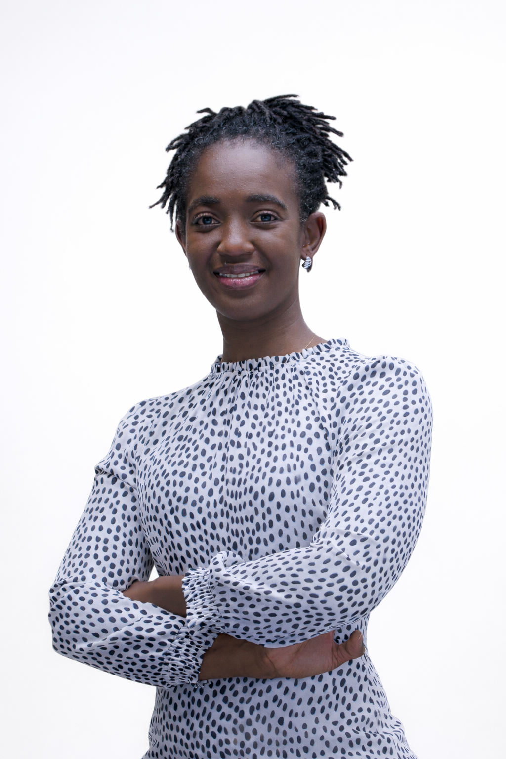 Thoko 17.1 Woman in a white and black polka dot blouse, smiling confidently like a CPA against a plain white background.